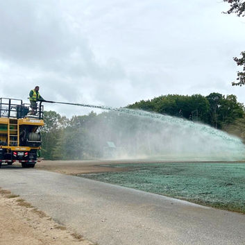 Hydroseeding equipment spraying a field